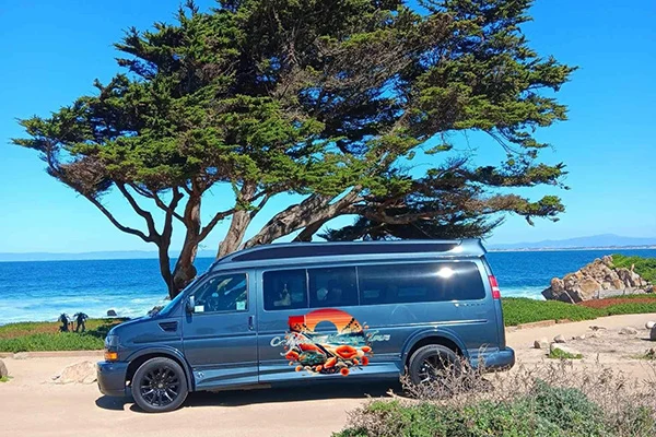 California Horizon Tours' private van beside the coast
